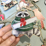 Load image into Gallery viewer, Festive Raccoon Wooden Ornament
